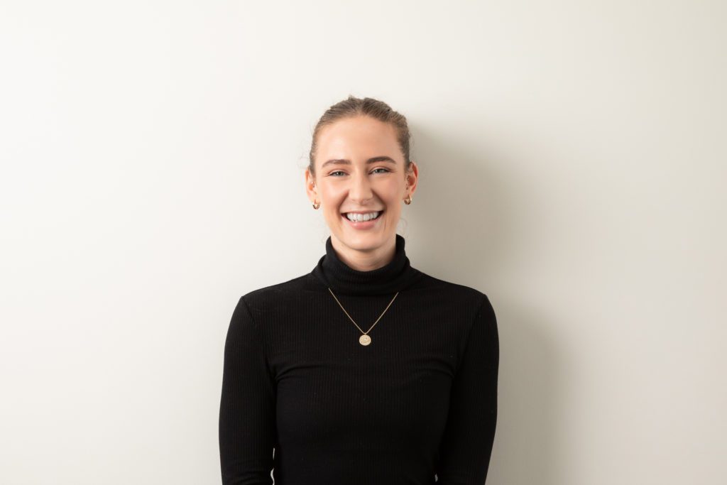 woman smiling with a black turtle neck
