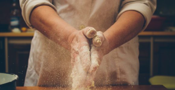 Baker working with flour.