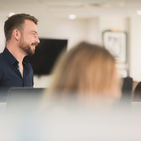 man standing at desk in an office