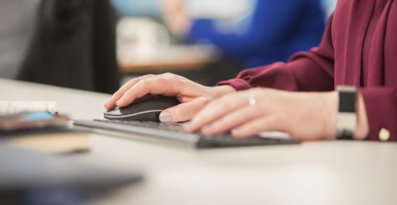 hands typing on a keyboard